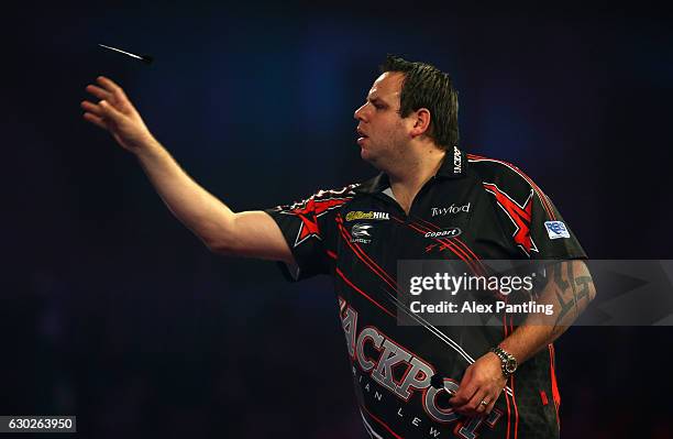 Adrian Lewis of England throws during his first round match against Magnus Caris of Sweden during day five of the 2017 William Hill PDC Darts...