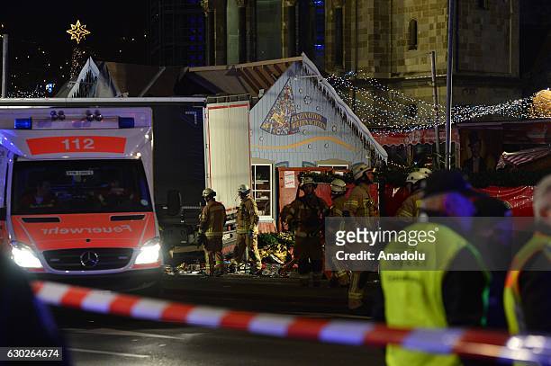 Paramedics and police arrive at a scene where a truck ploughed into a Christmas market killing at least nine and injuring several people in western...