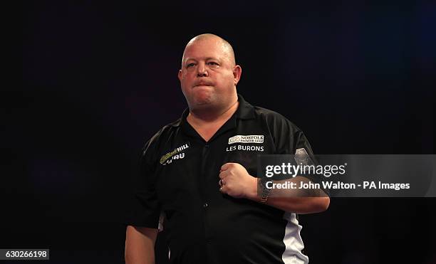 Mervyn King celebrates defeating Steve West during day five of the William Hill World Darts Championship at Alexandra Palace, London.
