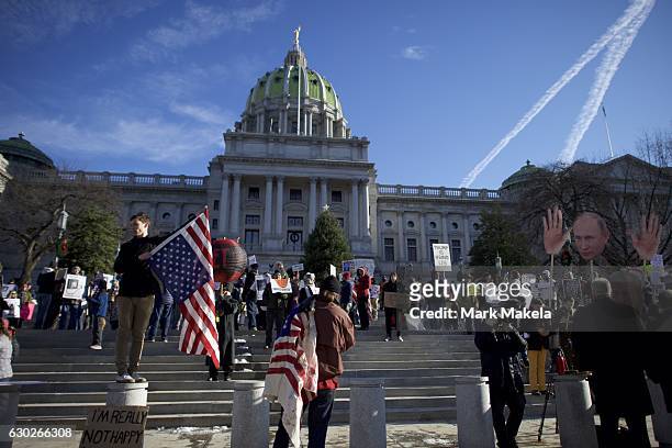 Donald Trump protestors demonstrate outside the Pennsylvania Capitol Building before electors arrive to cast their votes from the election at...