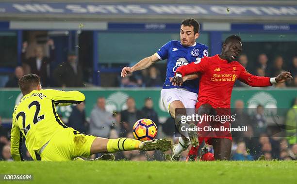 Sadio Mane of Liverpool is foiled by Leighton Baines and Maarten Stekelenburg of Everton during the Premier League match between Everton and...