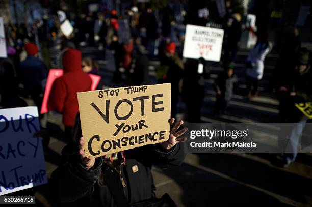 Donald Trump protestors demonstrate outside the Pennsylvania Capitol Building before electors arrive to cast their votes from the election at...