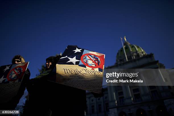 Donald Trump protestors demonstrate outside the Pennsylvania Capitol Building before electors arrive to cast their votes from the election at...