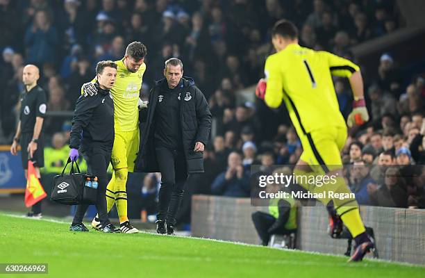 Injured goalkeeper Maarten Stekelenburg of Everton is replaced by substitute Joel Robles of Everton during the Premier League match between Everton...