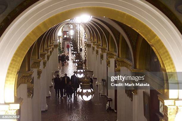 Demonstrators and visitors walk the hallway inside the Pennsylvania Capitol Building towards the House of Representatives chamber before electors...