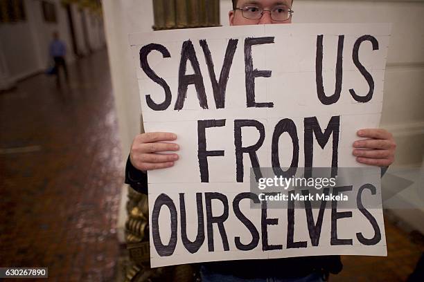 Donald Trump protestor joins demonstrators inside the Pennsylvania Capitol Building before electors arrive to cast their votes from the election at...