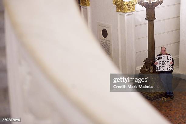Donald Trump protestor joins demonstrators inside the Pennsylvania Capitol Building before electors arrive to cast their votes from the election at...