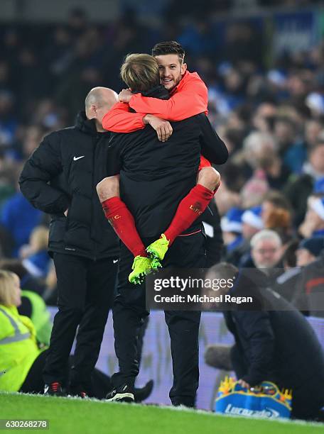 Jurgen Klopp manager of Liverpool and Adam Lallana of Liverpool celebrate victory after the Premier League match between Everton and Liverpool at...