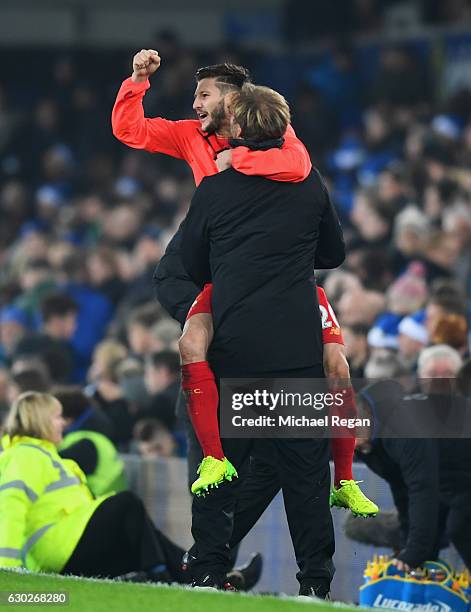 Jurgen Klopp manager of Liverpool and Adam Lallana of Liverpool celebrate victory after the Premier League match between Everton and Liverpool at...