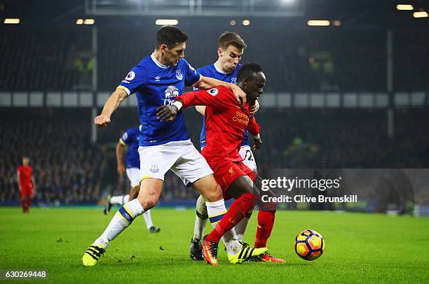 Sadio Mane of Liverpool battles with Gareth Barry and Seamus Coleman of Everton during the Premier League match between Everton and Liverpool at...