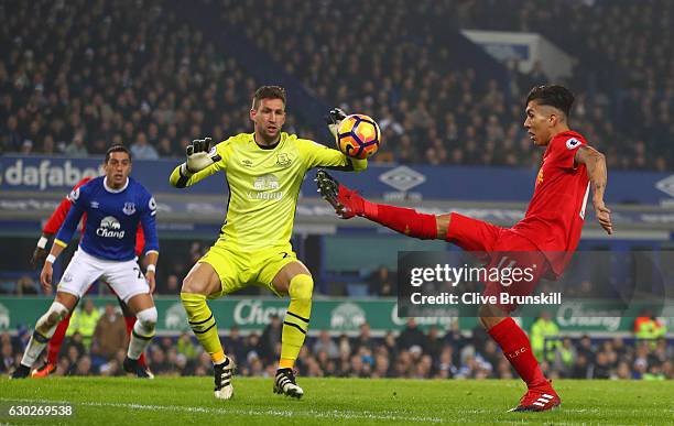 Roberto Firmino of Liverpool controls the ball as Maarten Stekelenburg of Everton looks on during the Premier League match between Everton and...