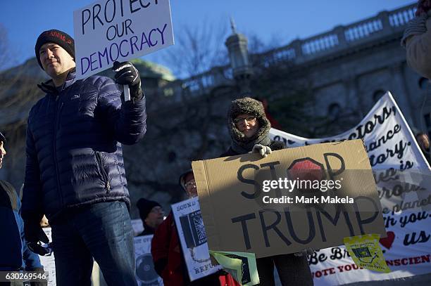 Donald Trump protestors demonstrate outside the Pennsylvania Capitol Building before electors arrive to cast their votes from the election December...