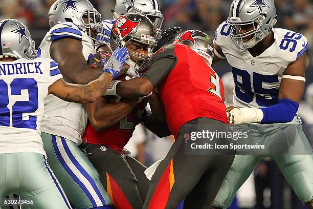 Doug Martin of the Buccaneers is stopped by the Cowboys defense as Bucs QB Jameis Winston comes to the aid of his runningback a moment before head...