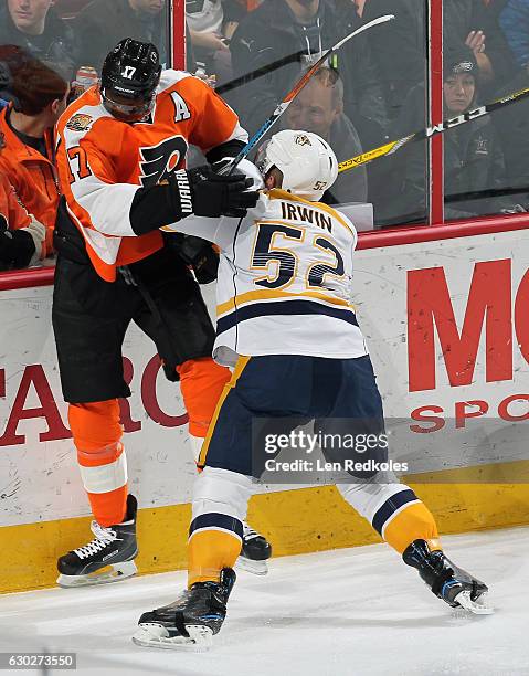 Matt Irwin of the Nashville Predators checks Wayne Simmonds of the Philadelphia Flyers into the boards on December 19, 2016 at the Wells Fargo Center...