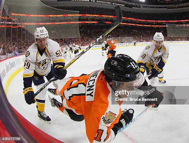 Roman Josi of the Nashville Predators hits Travis Konecny of the Philadelphia Flyers during the second period at the Wells Fargo Center on December...