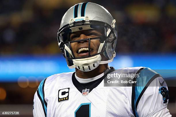 Quarterback Cam Newton of the Carolina Panthers celebrates after throwing a first quarter touchdown to teammate wide receiver Ted Ginn against the...