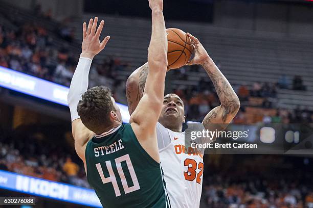 Baylee Steele of the Eastern Michigan Eagles guards as DaJuan Coleman of the Syracuse Orange shoots the ball during the second half on December 19,...