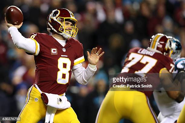 Quarterback Kirk Cousins of the Washington Redskins passes the ball while teammate guard Shawn Lauvao of the Washington Redskins blocks against the...