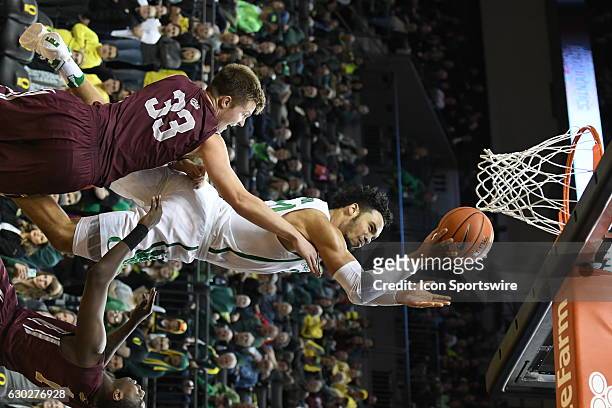 University of Oregon junior forward Dillon Brooks goes in for a layup over University of Montana redshirt-freshman Jared Samuelson during a...