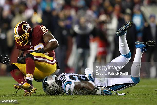 Wide receiver Pierre Garcon of the Washington Redskins carries the ball against cornerback James Bradberry of the Carolina Panthers in the second...