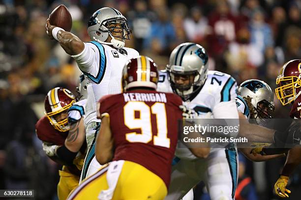 Quarterback Cam Newton of the Carolina Panthers passes the ball while teammate guard Trai Turner blocks against outside linebacker Ryan Kerrigan of...