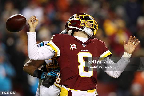 Quarterback Kirk Cousins of the Washington Redskins fumbles the ball in the third quarter against the Carolina Panthers at FedExField on December 19,...