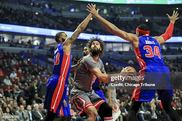 Detroit Pistons forward Marcus Morris and forward Tobias Harris guard Chicago Bulls center Robin Lopez during the first half on Monday, Dec. 19, 2016...