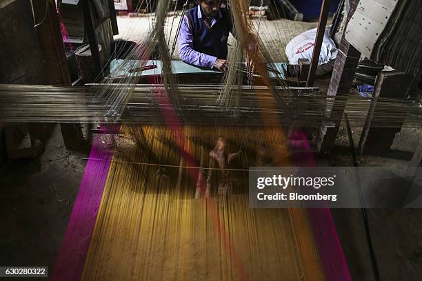 Weaver uses a handloom to make a silk sari at a workshop in Varanasi, Uttar Pradesh, India, on Thursday, Dec. 8, 2016. Indian Prime Minister Narendra...