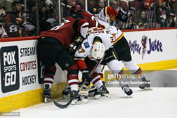 Calgary Flames defenseman Dougie Hamilton gets caught between Arizona Coyotes right wing Tobias Rieder and Arizona Coyotes center Ryan White during...