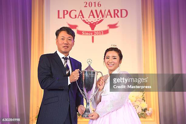 Bo-Mee Lee of South Korea and the representative Director,President & CEO at Mercedes-Benz Japan Kintaro Ueno of Japan pose with the trophy during...