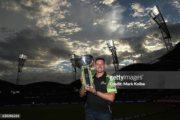 Former Sydney Thunder captain Michael Hussey poses with the 2015/16 Big Bash trophy the Big Bash League match between the Sydney Thunder and the...