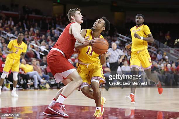 Jordan McLaughlin of the USC Trojans handles the ball against Stone Gettings of the Cornell Big Red during a NCAA college basketball game at Galen...