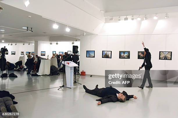 Graphic content / A picture taken on December 19, 2016 shows Andrei Karlov, the Russian ambassador to Ankara, lying on the floor after being shot by...