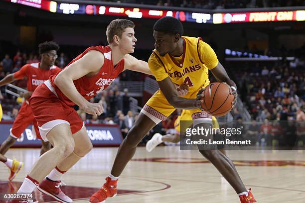 Chimezie Metu of the USC Trojans handles the ball against Stone Gettings of the Cornell Big Red during a NCAA college basketball game at Galen Center...