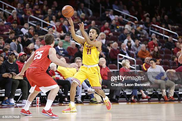 Jordan McLaughlin of the USC Trojans handles the ball against JoJo Fallas of the Cornell Big Red during a NCAA college basketball game at Galen...