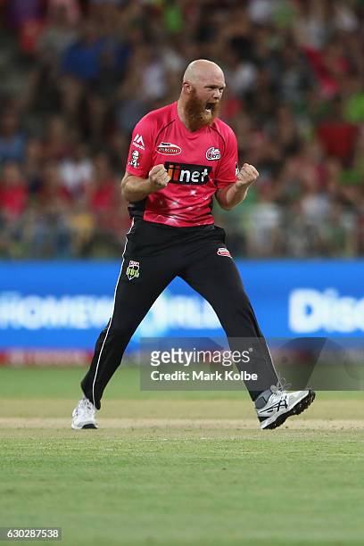 Doug Bollinger of the Sixers celebrates taking the wicket of Andre Russell of the Thunder during the Big Bash League match between the Sydney Thunder...