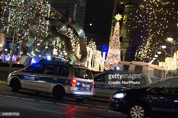 Policemen secure a street conducting to the area where a lorry truck drove through the Chrismas Market by the Kaiser Wilhelm Gedaechtniskirche...