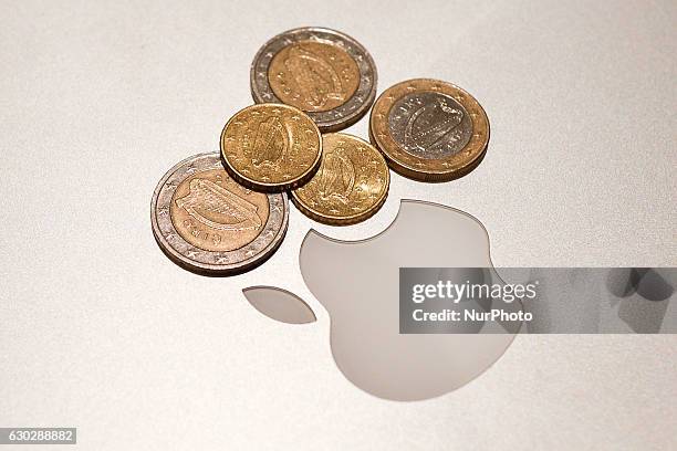 Irish euro coins beside Apple's logo. Apple launched a legal challenge against the $14 billion the EU claims it owes in taxes. As per the European...