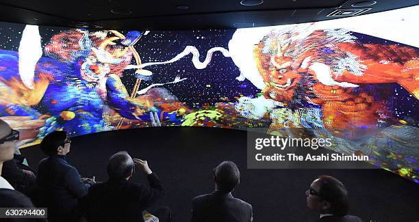 Visitors enjoy 3D artworks by artist Koji Kinutani during the press preview of the Koji Kinutani Tenku Art Museum azt Umeda Sky Building on December...