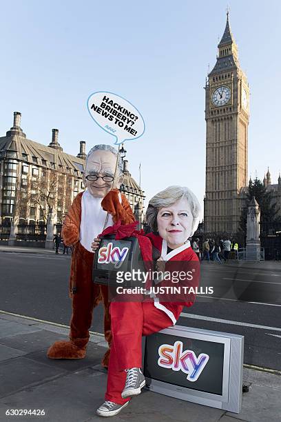 Campaigners dressed up as Australian-born media mogul Murdoch and British Prime Minister Theresa May protest against Murdochs 21st Century Fox...