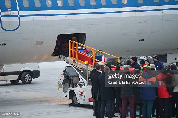 The flag-wrapped coffin of late Russian Ambassador to Turkey Andrei Karlov is loaded to a plane during a ceremony at Esenboga airport on December 20,...