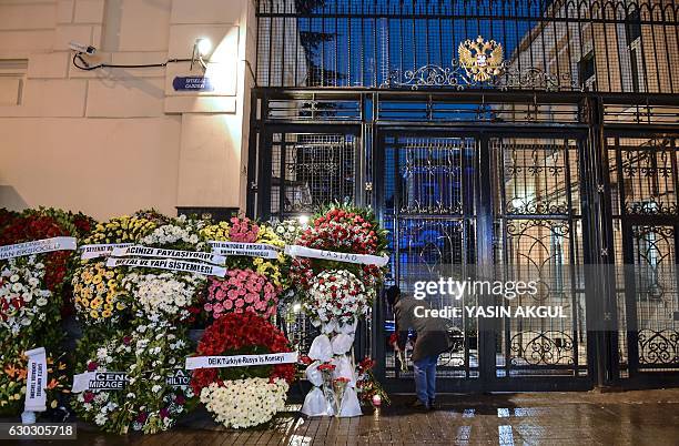 Man lays flowers outside the Russian Consulate in Istanbul on December 20 in tribute to late Russian ambassador assassinated the day before in the...