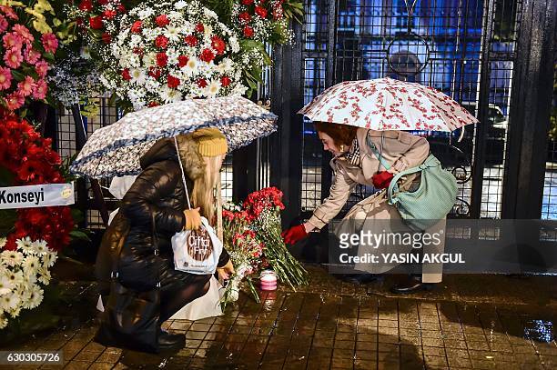 Women lay flowers outside the Russian Consulate in Istanbul on December 20 in tribute to late Russian ambassador assassinated the day before in the...