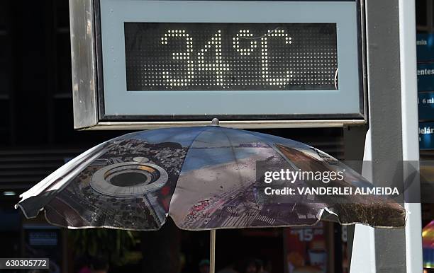 Steet digital clock marks 34 degrees Celsius in the center of Rio de Janeiro, Brazil on December 20, 2016 during the last day of spring, anticipating...