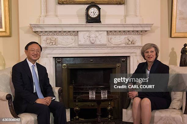 British Prime Minister Theresa May sits with Chinese State Councillor Yang Jiechi for a meeting at 10 Downing Street in London on December 20, 2016....