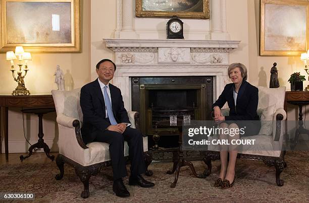 British Prime Minister Theresa May sits with Chinese State Councillor Yang Jiechi for a meeting at 10 Downing Street in London on December 20, 2016....