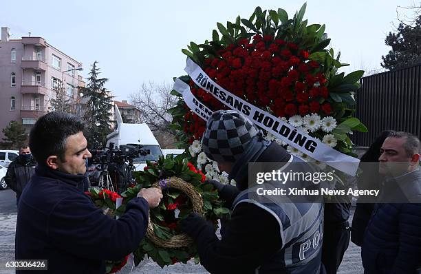 Dec. 20, 2016 -- A Turkish police checks a wreath near the Russian Embassy in Ankara, Turkey on Dec. 20 a day after Russian Ambassador to Turkey...