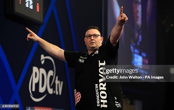 Dragutin Horvat celebrates on his way to defeating Boris Koltsov during day six of the William Hill World Darts Championship at Alexandra Palace,...