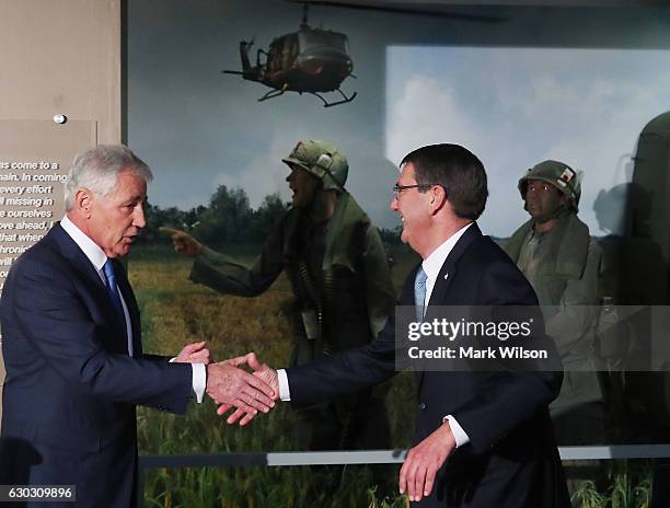 Defense Secretary Ashton Carter and Vietnam War veteran and former Defense Secretary Chuck Hagel participate in the unveiling of an exhibit honoring...