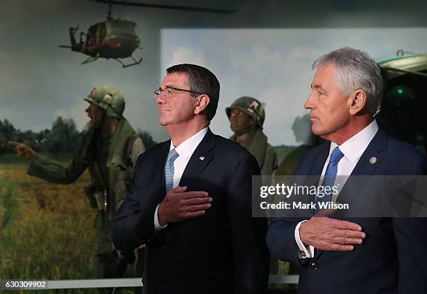 Defense Secretary Ashton Carter , and Vietnam War veteran and former Defense Secretary Chuck Hagel participate in the unveiling of an exhibit...